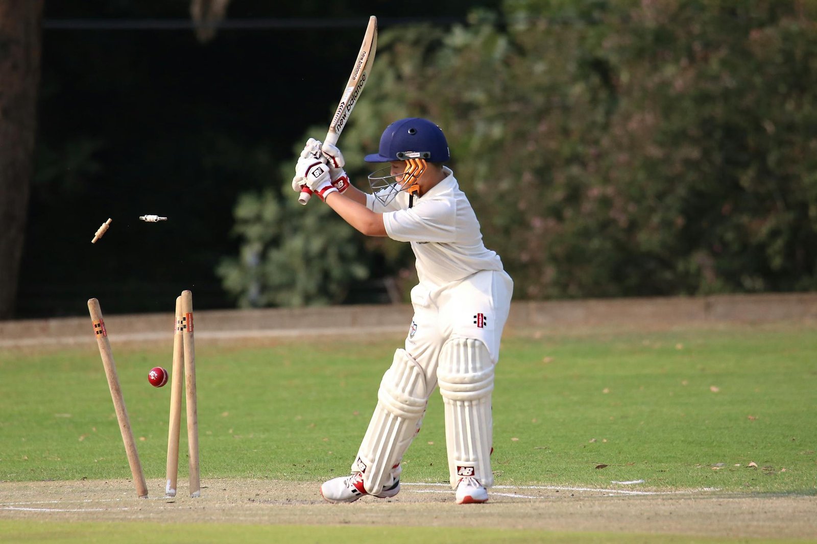 Young cricket player in focused action on the field. Capturing the moment of impact.